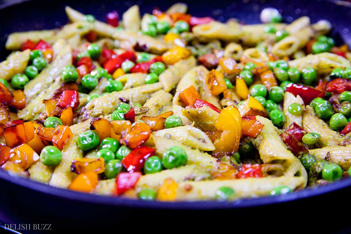 This entirely satisfying, vegan cashew pesto penne pasta is light, amazing to look at and easy on your stomach. Creamy cashew pesto with fresh peppery sauce coats perfectly cooked al dente penne. This simple dish is easy to make and is a feast of colors. | www.delishbuzz.com