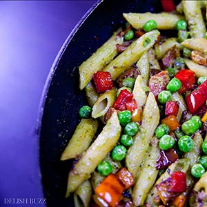 This entirely satisfying, vegan cashew pesto penne pasta is light, amazing to look at and easy on your stomach. Creamy cashew pesto with fresh peppery sauce coats perfectly cooked al dente penne. This simple dish is easy to make and is a feast of colors. | www.delishbuzz.com