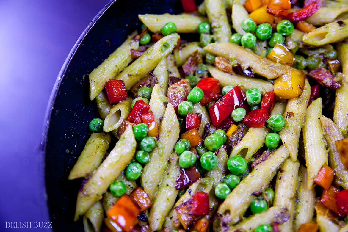 This entirely satisfying, vegan cashew pesto penne pasta is light, amazing to look at and easy on your stomach. Creamy cashew pesto with fresh peppery sauce coats perfectly cooked al dente penne. This simple dish is easy to make and is a feast of colors. | www.delishbuzz.com