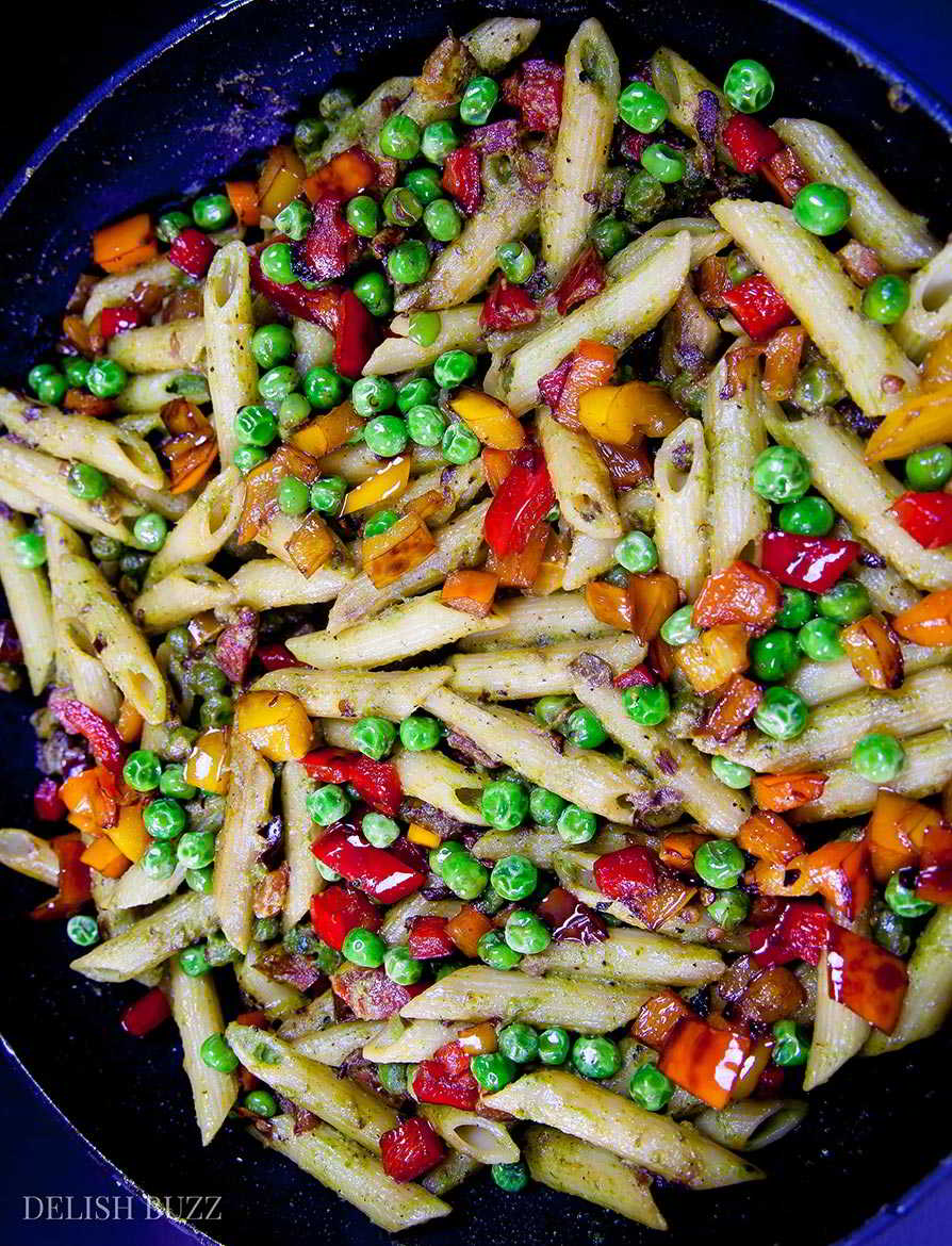 This entirely satisfying, vegan cashew pesto penne pasta is light, amazing to look at and easy on your stomach. Creamy cashew pesto with fresh peppery sauce coats perfectly cooked al dente penne. This simple dish is easy to make and is a feast of colors. | www.delishbuzz.com