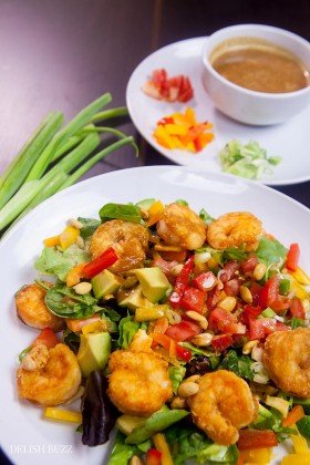 Shrimp avocado salad, a wonderfully satisfying main course salad. Crunchy, sweet, sour and nutty. This colorful salad explodes with flavors and textures. At the same time, it brings together luscious greens, sweet peppers, scallions, peanuts and creamy avocados with a perfectly crafted dressing. www.delishbuzz.com