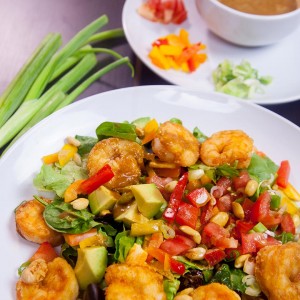 Shrimp avocado salad, a wonderfully satisfying main course salad. Crunchy, sweet, sour and nutty. This colorful salad explodes with flavors and textures. At the same time, it brings together luscious greens, sweet peppers, scallions, peanuts and creamy avocados with a perfectly crafted dressing. www.delishbuzz.com