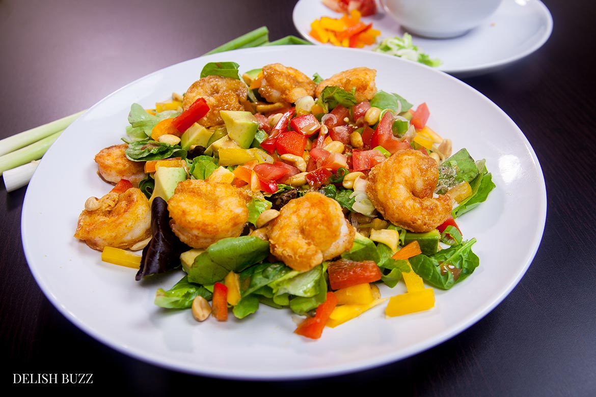 Shrimp avocado salad, a wonderfully satisfying main course salad. Crunchy, sweet, sour and nutty. This colorful salad explodes with flavors and textures. At the same time, it brings together luscious greens, sweet peppers, scallions, peanuts and creamy avocados with a perfectly crafted dressing. www.delishbuzz.com
