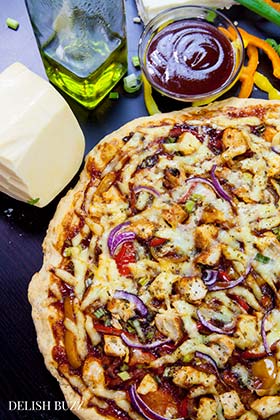 Smoked Gouda and smoked paprika do wonders here! Easy Barbecue Chicken Pizza explodes with flavors in your mouth. Instant no rise homemade crust along with barbecue sauce, sweet peppers and gouda cheese makes this pizza irresistible. www.delishbuzz.com