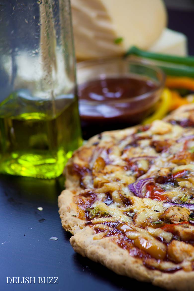 Sweet, smokey and savory! Easy Barbeque Chicken Pizza explodes with flavors in your mouth. Instant no rise homemade crust along with barbeque sauce, sweet peppers and gouda cheese makes this pizza irresistible. www.delishbuzz.com