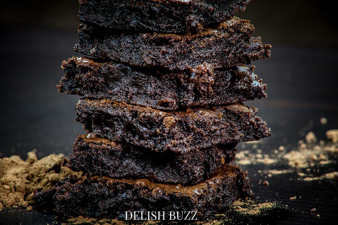 Homemade brownies will fill your homes with divine smell of cacoa! Fudgiest homemade chocolate brownies!! Simple easy brownie recipe but addicting outcome! High cocoa ratio in this recipe results in the chewiest fudgiest brownies ever www.delishbuzz.com