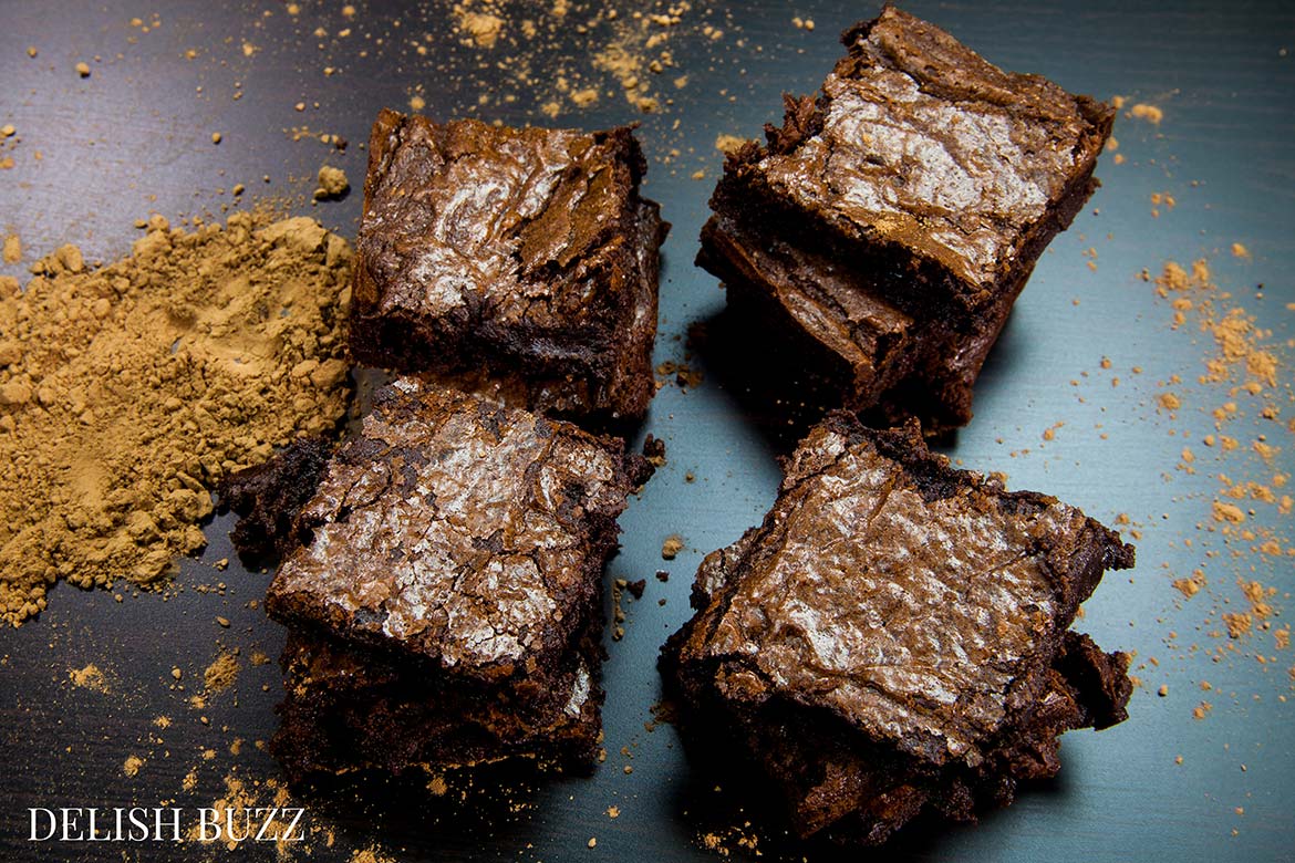These are fudgy and moist chocolate heaven! Fudgiest homemade chocolate brownies!! Simple easy brownie recipe but addicting outcome! High cocoa ratio in this recipe results in the chewiest fudgiest brownies ever www.delishbuzz.com
