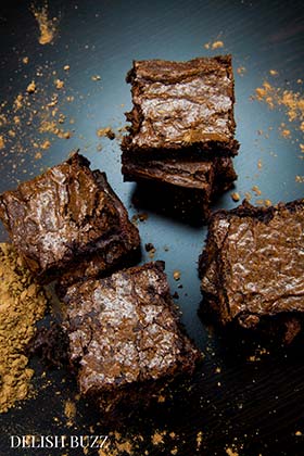 Shiny, chocolaty heavenly slices! Fudgiest homemade chocolate brownies!! Simple easy brownie recipe but addicting outcome! High cocoa ratio in this recipe results in the chewiest fudgiest brownies ever www.delishbuzz.com