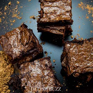 Shiny, chocolaty heavenly slices! Fudgiest homemade chocolate brownies!! Simple easy brownie recipe but addicting outcome! High cocoa ratio in this recipe results in the chewiest fudgiest brownies ever www.delishbuzz.com