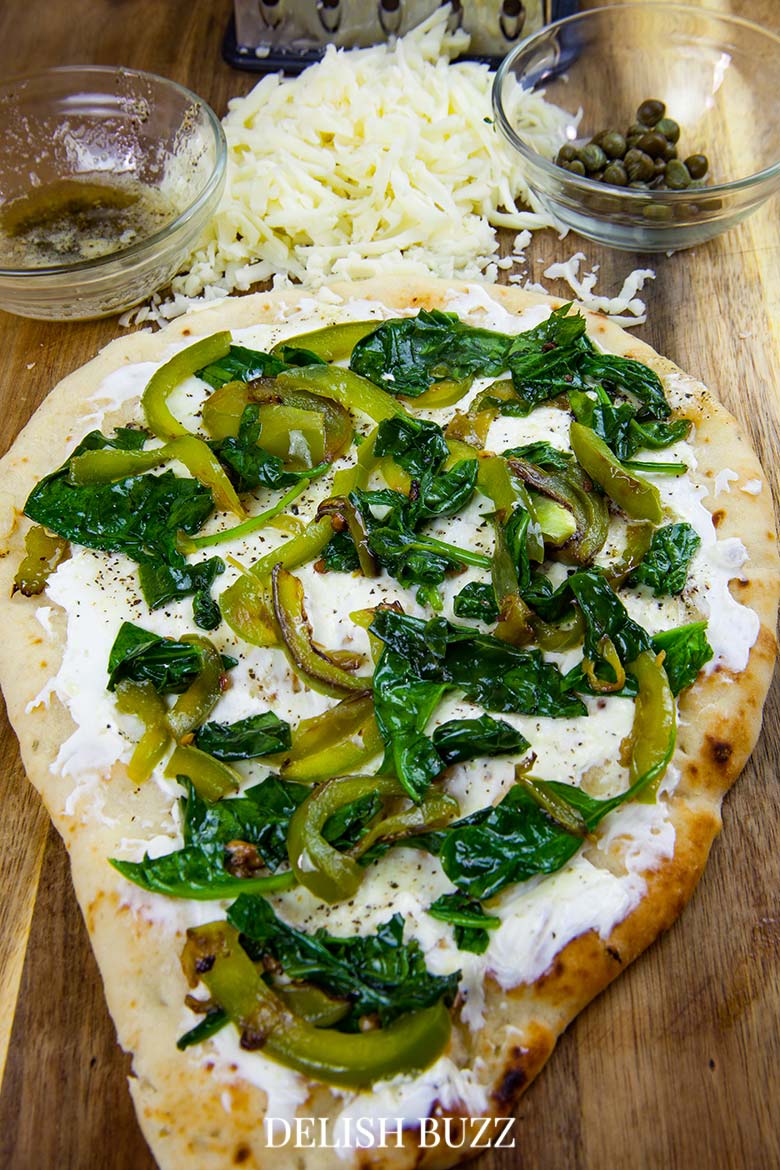 We love the colors here. Prep work is so easy for this flatbread pizza. Basil butter naan white pizza is as good as artisan pizzas. This recipe will make you realize how easy it is whip up a delicious flatbread pizza at home. - www.delishbuzz.com