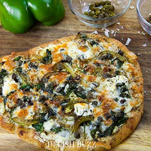 Basil butter naan white pizza is as good as artisan pizzas. This recipe will make you realize how easy it is whip up a delicious flatbread pizza at home. - www.delishbuzz.com