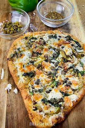 I want this now! Perfect colors and aroma when this pizza is done! Basil butter naan white pizza is as good as artisan pizzas. This recipe will make you realize how easy it is whip up a delicious flatbread pizza at home. - www.delishbuzz.com