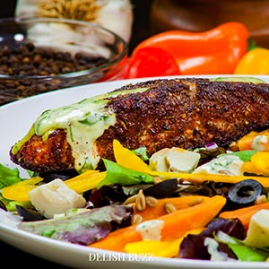 Crunchy, sweet, fresh salad! A very satisfying aroma rich creamy blackened salmon salad with a creamy homemade gingery dressing! Crunchy, creamy, salty, sweet salad with juicy salmon. www.delishbuzz.com