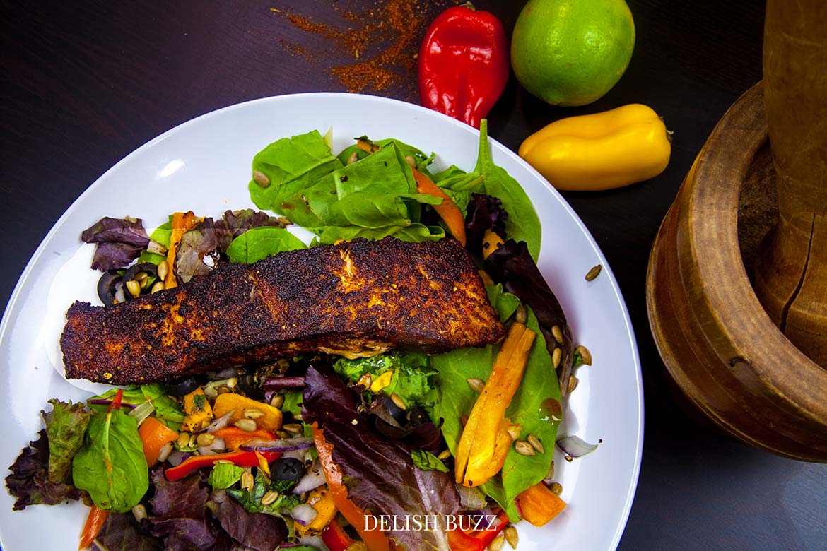 Delicious sweet potatoes, crispy sweet peppers add so much to this salad. A very satisfying aroma rich creamy blackened salmon salad with a creamy homemade gingery dressing! Crunchy, creamy, salty, sweet salad with juicy salmon. www.delishbuzz.com