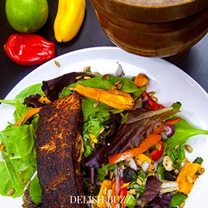 Close up of our finished salad! Vibrant and fragarant! A very satisfying aroma rich creamy blackened salmon salad with a creamy homemade gingery dressing! Crunchy, creamy, salty, sweet salad with juicy salmon. www.delishbuzz.com