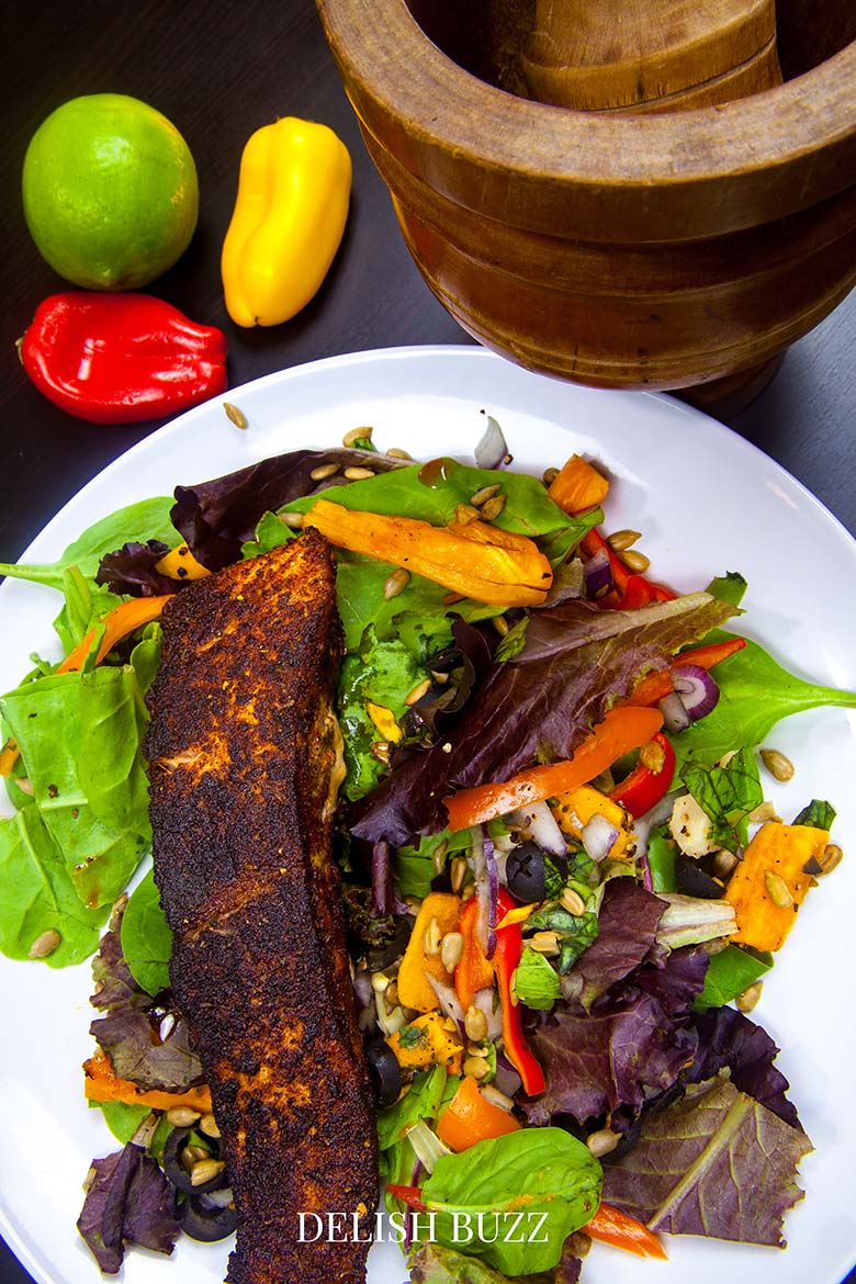 Close up of our finished salad! Vibrant and fragarant! A very satisfying aroma rich creamy blackened salmon salad with a creamy homemade gingery dressing! Crunchy, creamy, salty, sweet salad with juicy salmon. www.delishbuzz.com