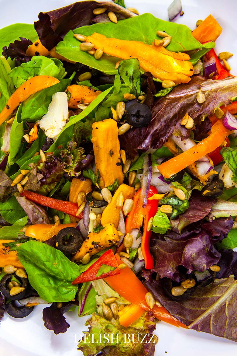 Colors of a great salad! A very satisfying aroma rich creamy blackened salmon salad with a creamy homemade gingery dressing! Crunchy, creamy, salty, sweet salad with juicy salmon. www.delishbuzz.com