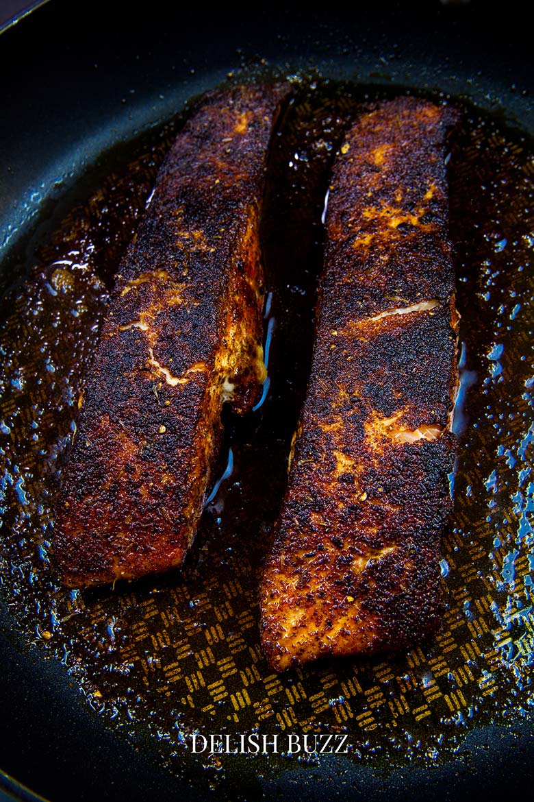 A very satisfying aroma rich creamy blackened salmon salad with a creamy homemade gingery dressing! Crunchy, creamy, salty, sweet salad with juicy salmon. www.delishbuzz.com